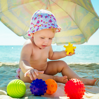 BABY-OP-HET-STRAND-ONDER-EEN-PARASOL